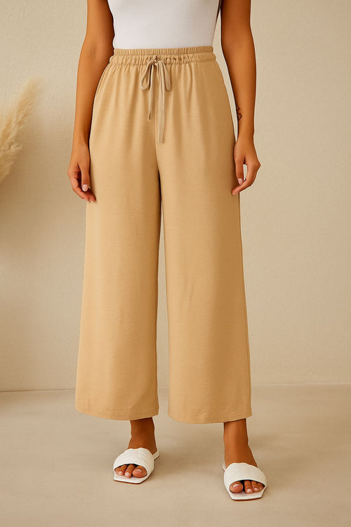 Pantaloni bej largi cu talie elastică – stil relaxat